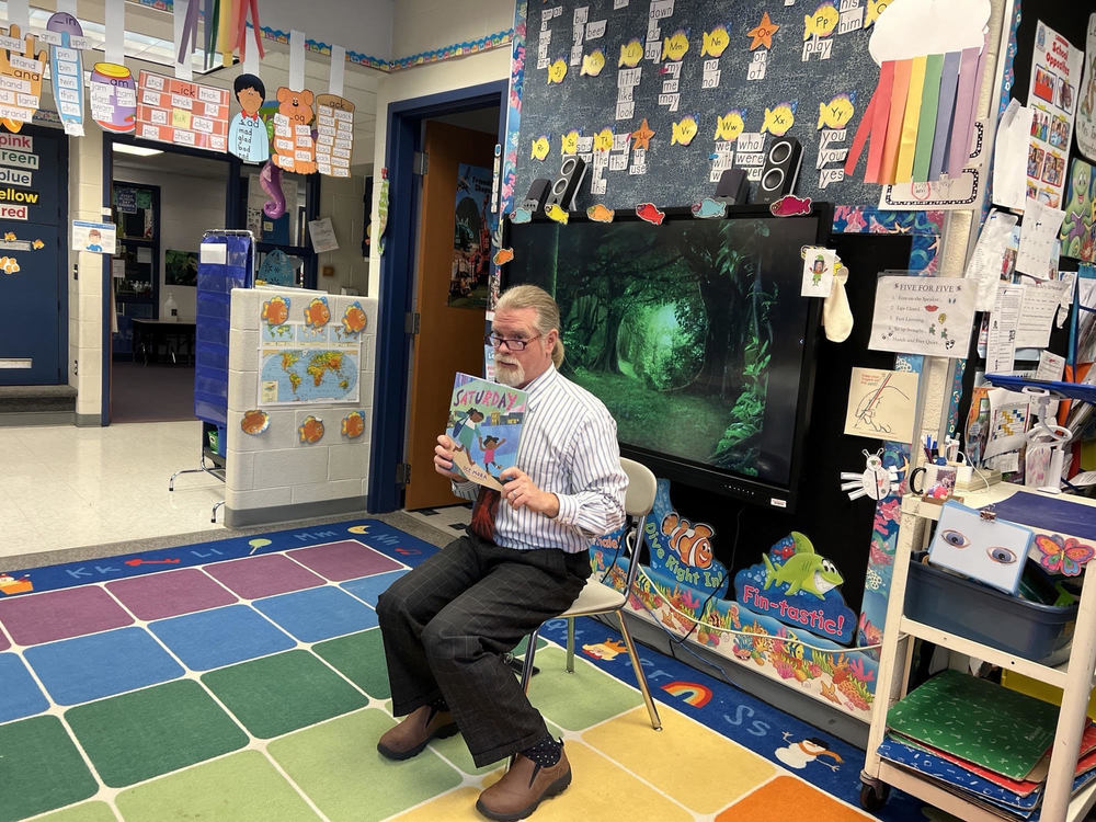 Community member reading to the class