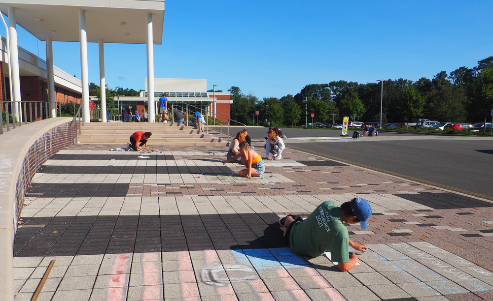 Students painting chalk murals for 9/11 memorial