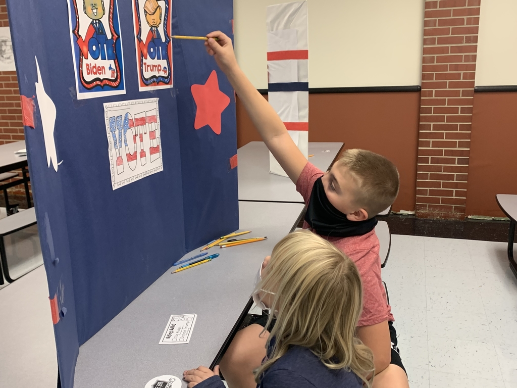 Carson reads the names of the candidates to a kindergarten student.