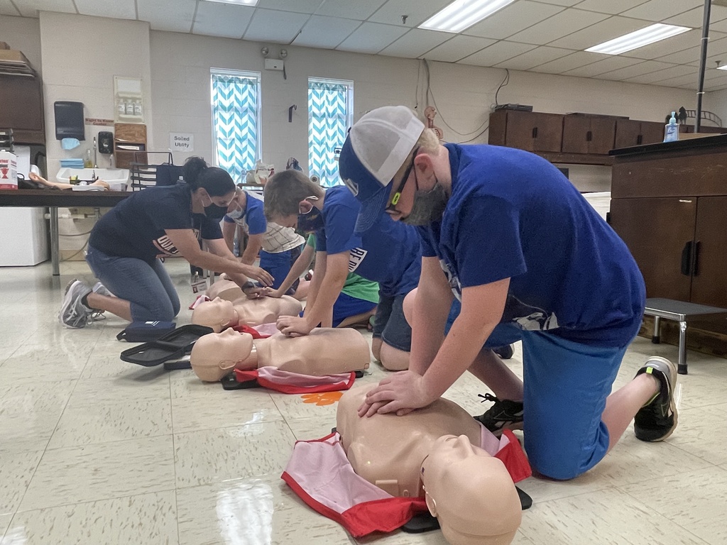 teacher leading boys in cpr instruction