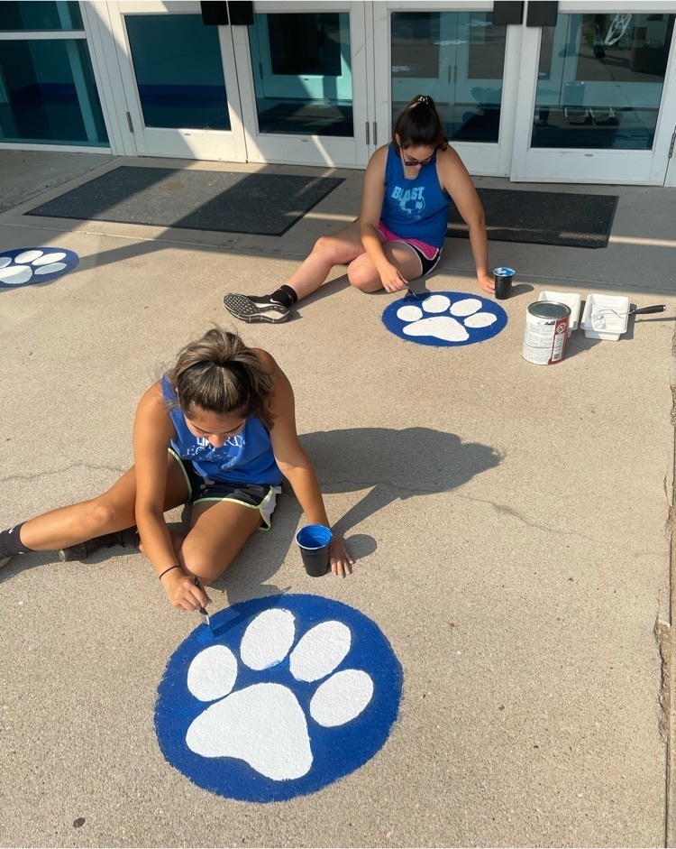 Tana and Yazmin finish touching up the last paw prints.