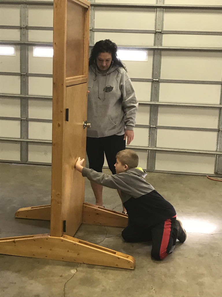 Feeling the door to make sure it’s safe to go through. 