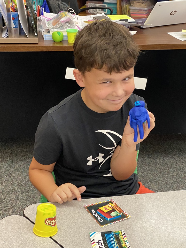 boy with playdough creation
