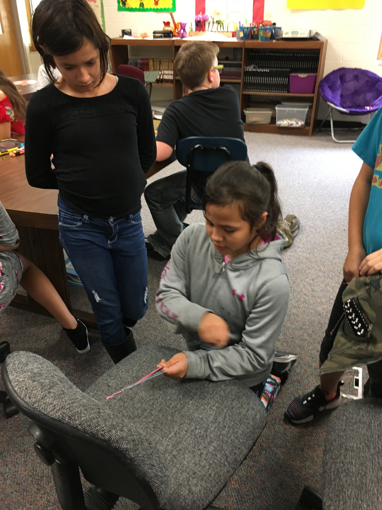 Teaching our friends how to make bracelets.