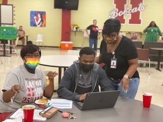 Mrs Kayla Jones assisting Senior Kearon Brown & his mom
