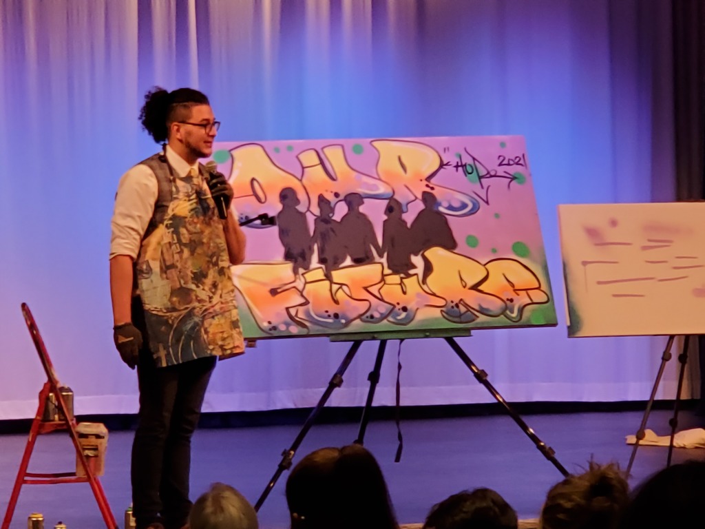 Artist Josh Arias, Co-founder of Impact Art in Kearney , spoke to the students while he spay painted this piece 