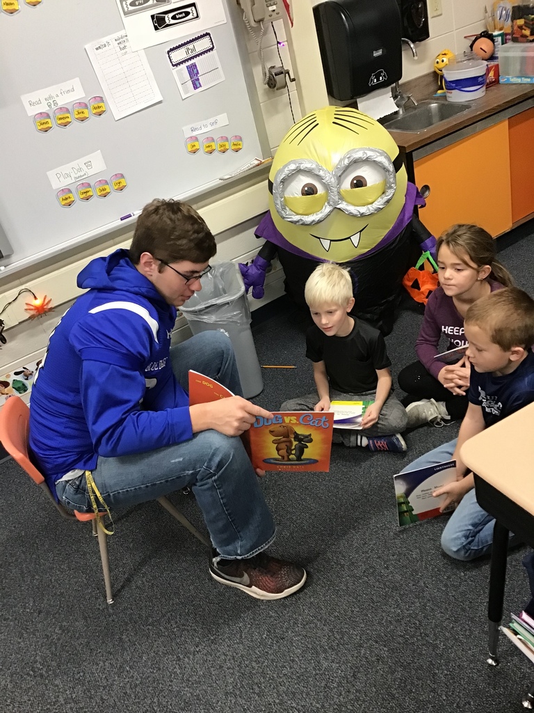 Ben reads Dog vs. Cat to first graders