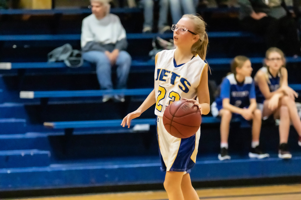 girl dribbles basketball