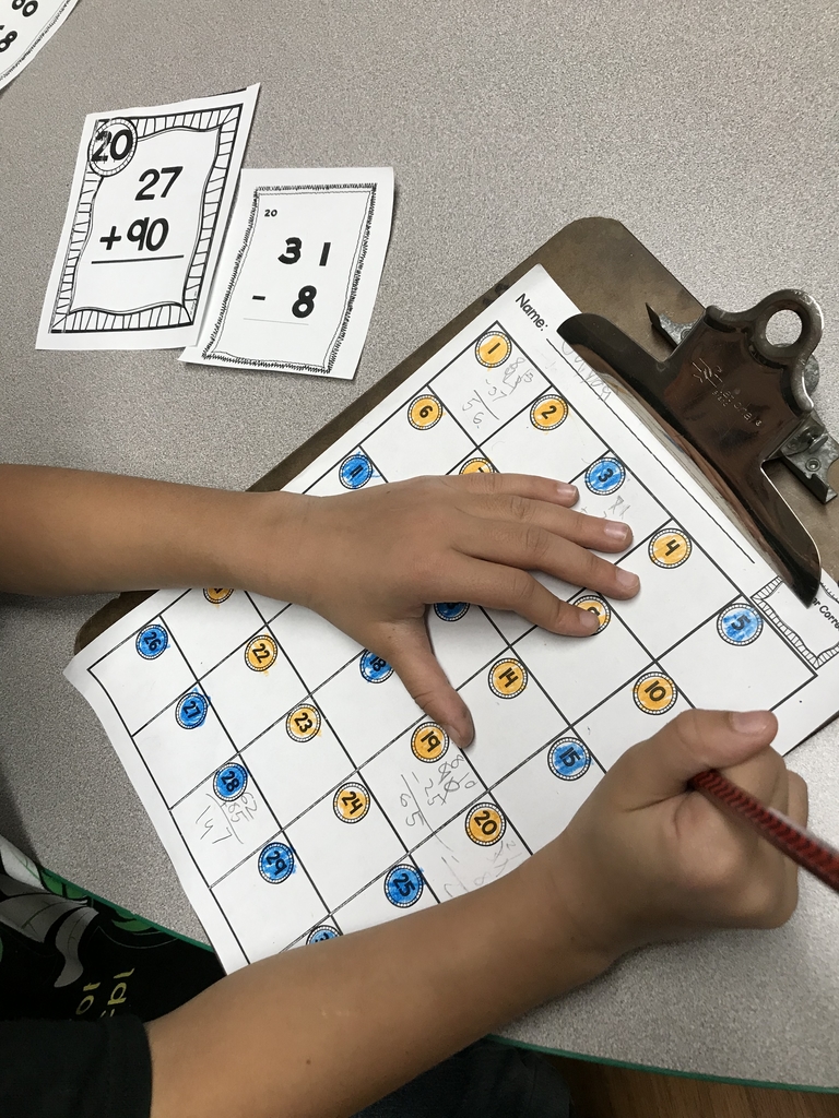 2A practicing addition and subtraction around the room while singing Christmas carols