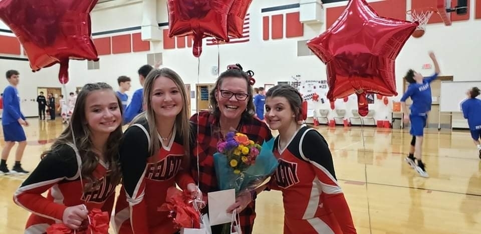 cheerleaders and coach
