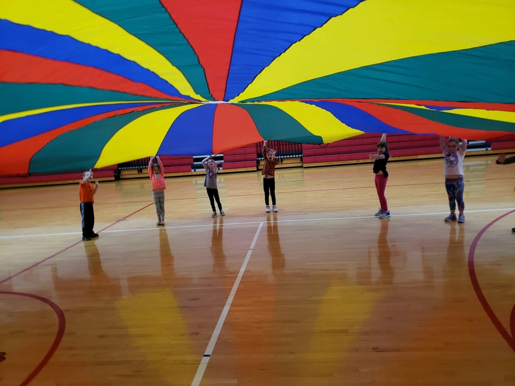 Waving to our friends under the parachute.