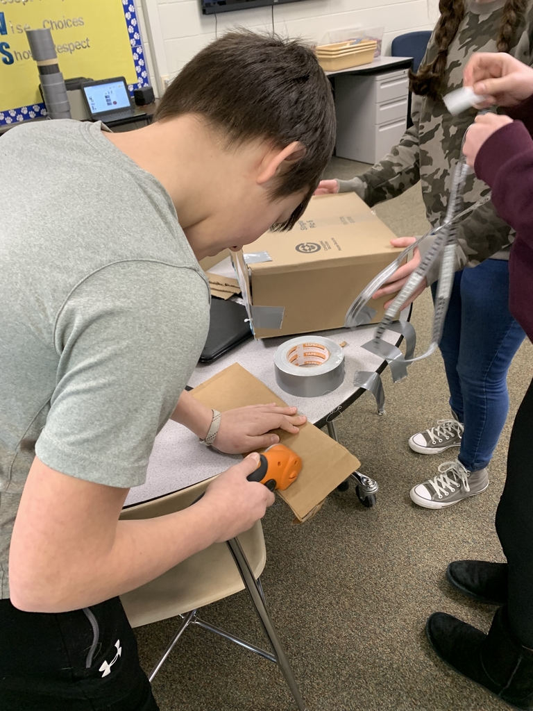 Using tools cut up cardboard.
