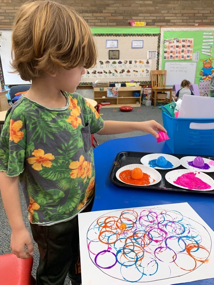 Lennox painting his egg.