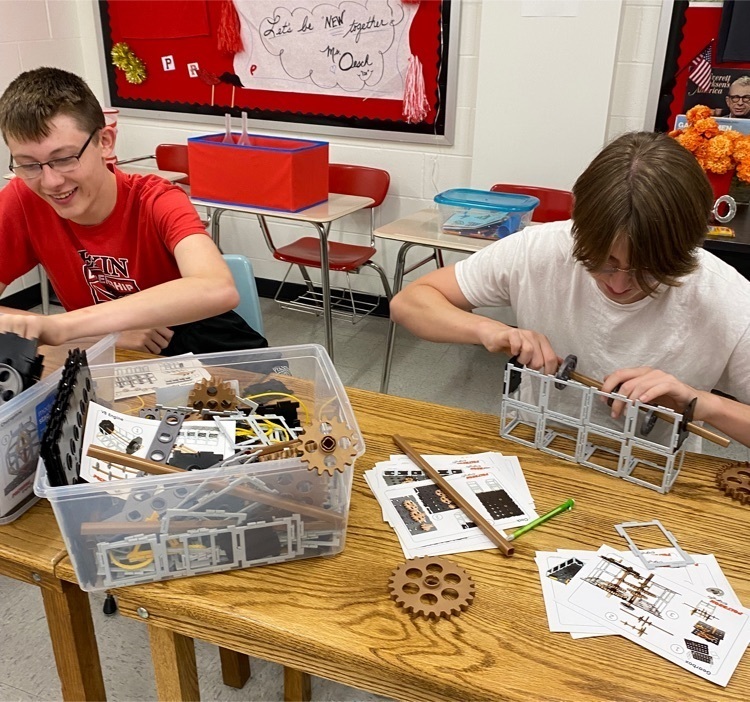 Engineers building a four cylinder engine!