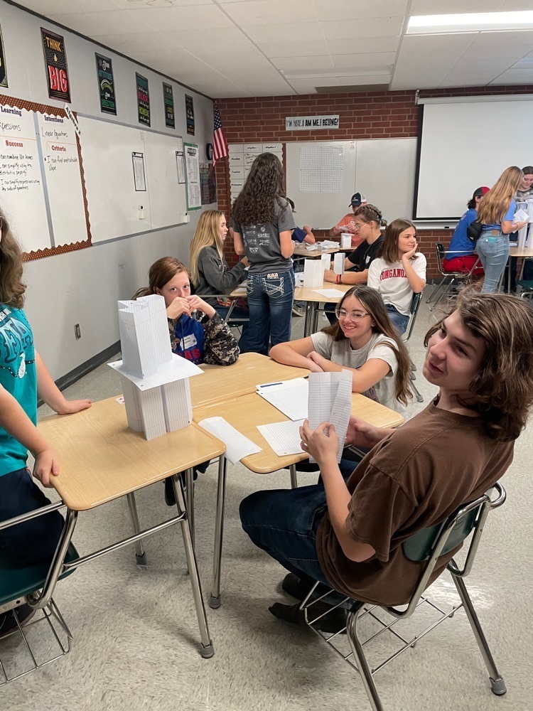 Hailey Farmer working with her group to build a tower.