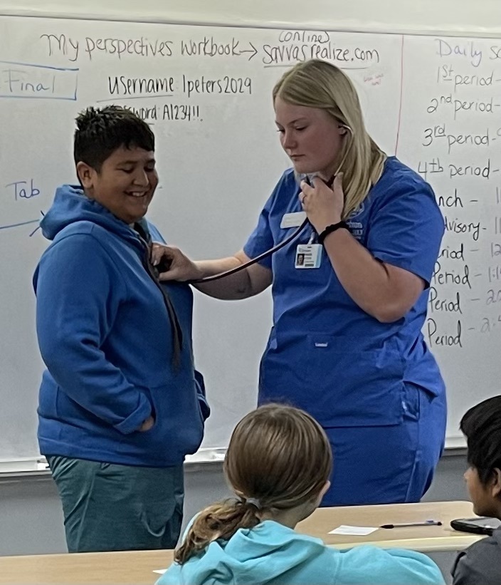 6th grade student has his heart listened to.