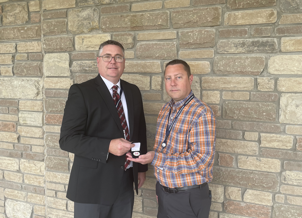 Doug Robinson and Jerrod Graybeal holding a medal 