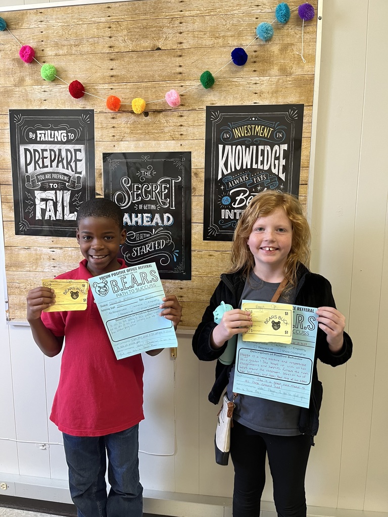a boy and a girl holding paper