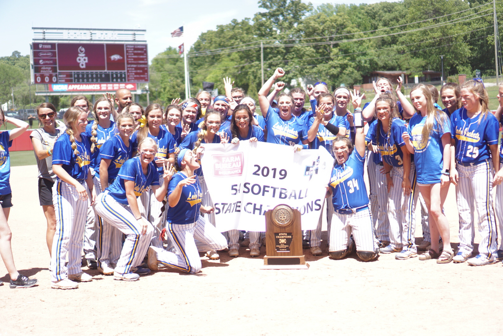Image of softball team with their trophy