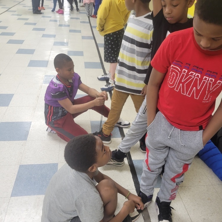 students tying shoes