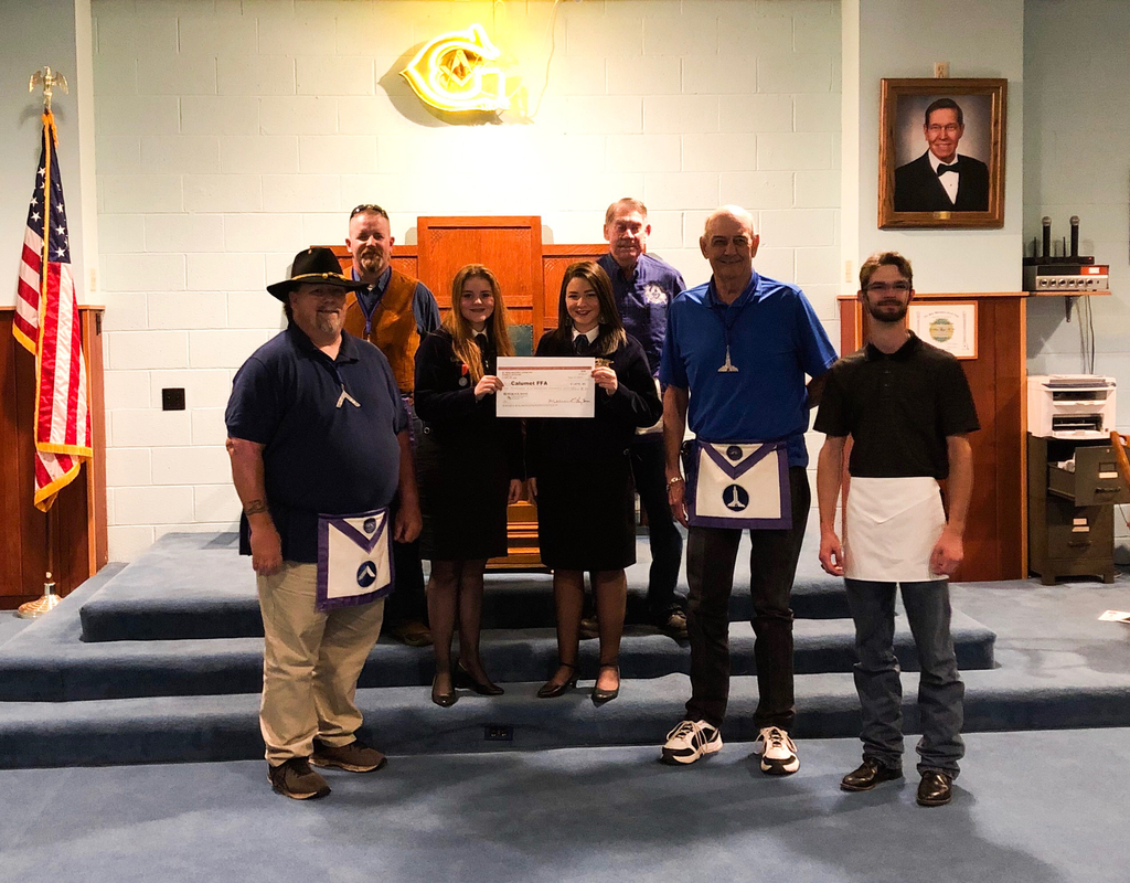 FFA Officers Lauren and Karla reviving a check from the Masonic Lodge in El Reno for WLC Scholarship.