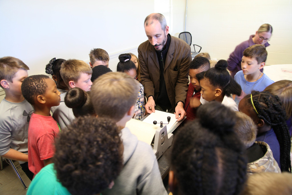 Students working on picasso faces in art