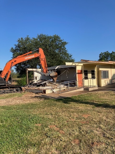 Portable being demolished by tractor