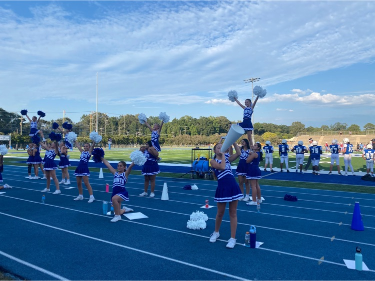 Cheerleaders perform a stunt