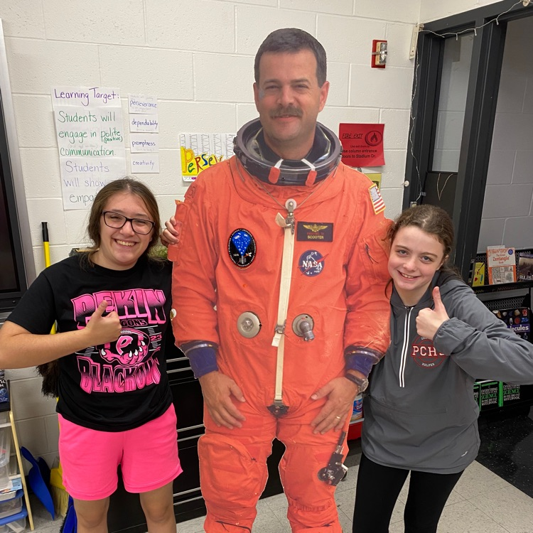 Mary and Gabby show “Flat" Scott their science classroom. 