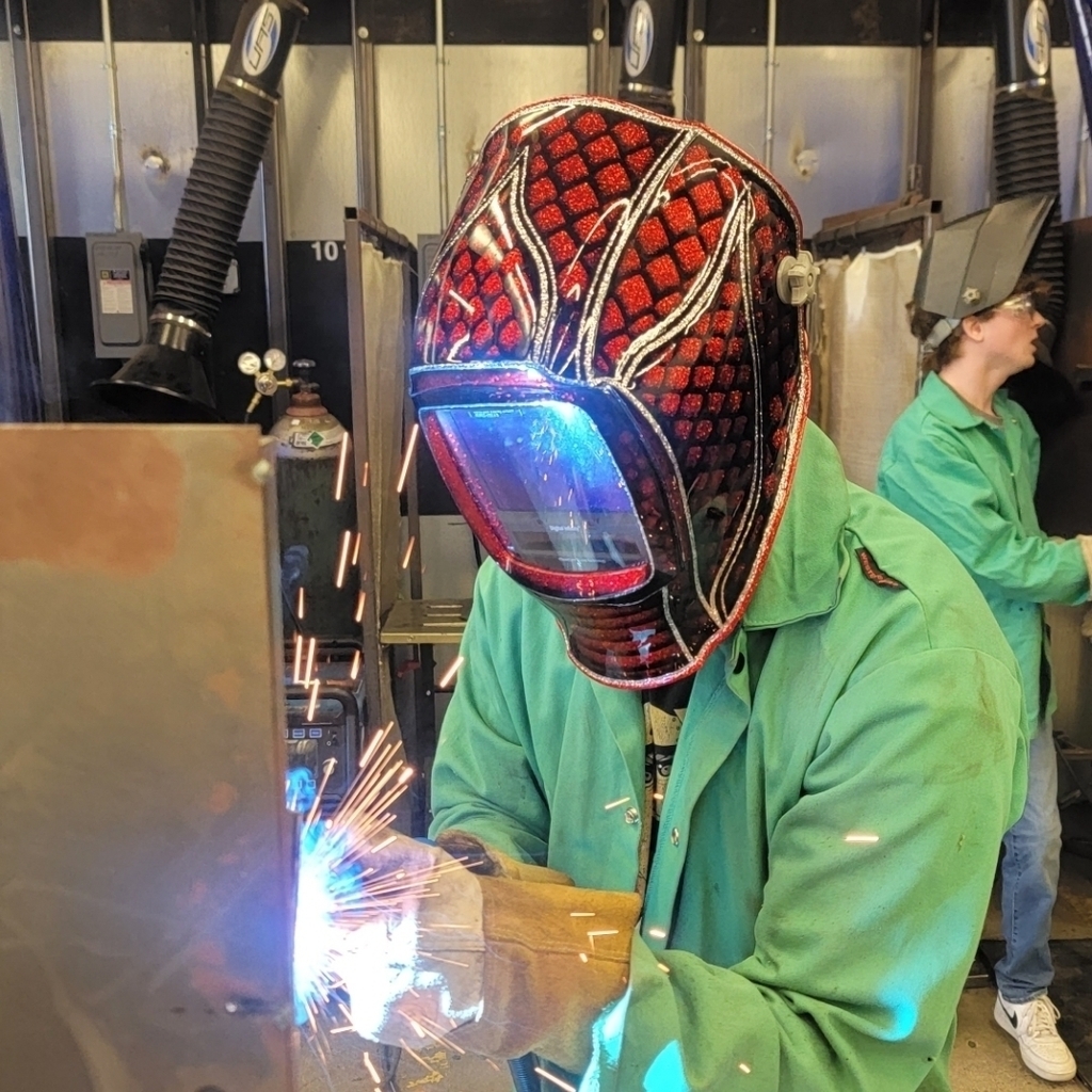 Tristin Durbin trying out Mr. Huskisson custom "dragon" welding helmet during 6th hour welding 1. 
