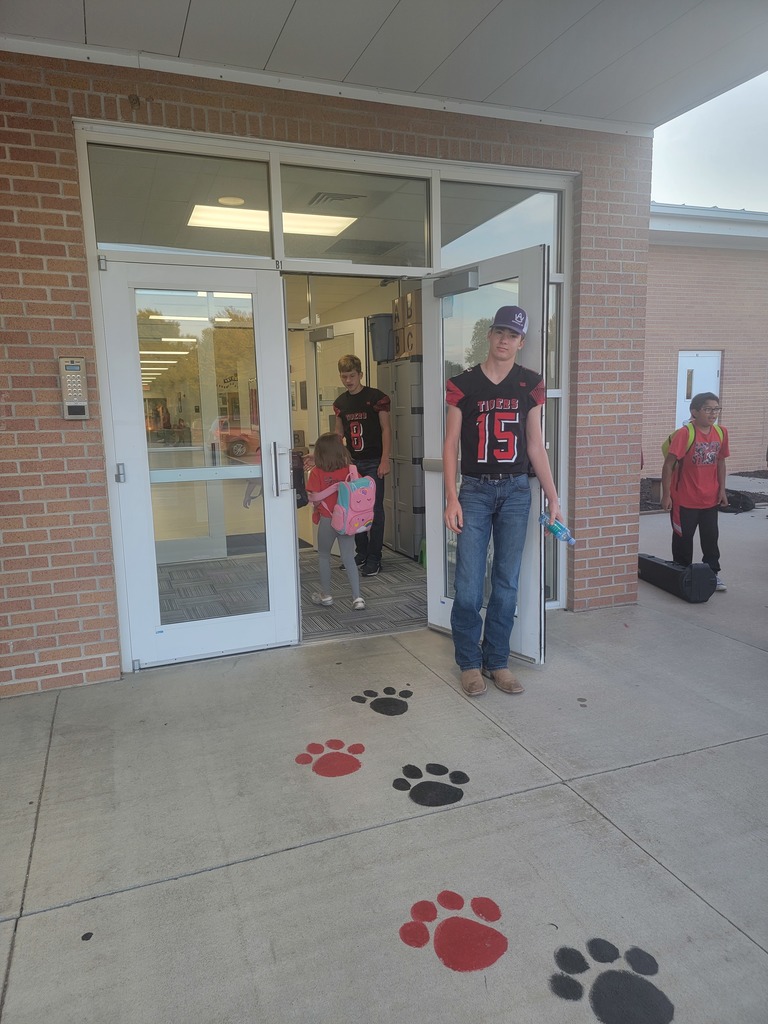 high school football boys with elementary students