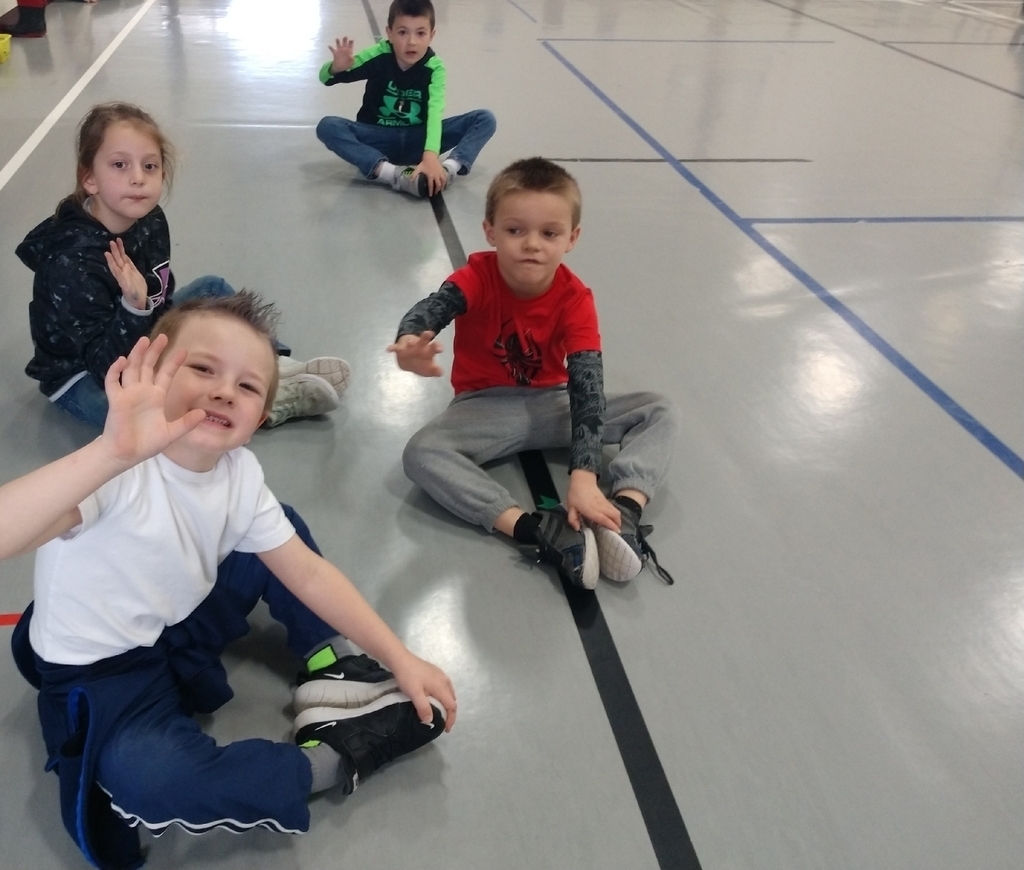 Kindergartners are having fun counting by fives during stretches in PE!