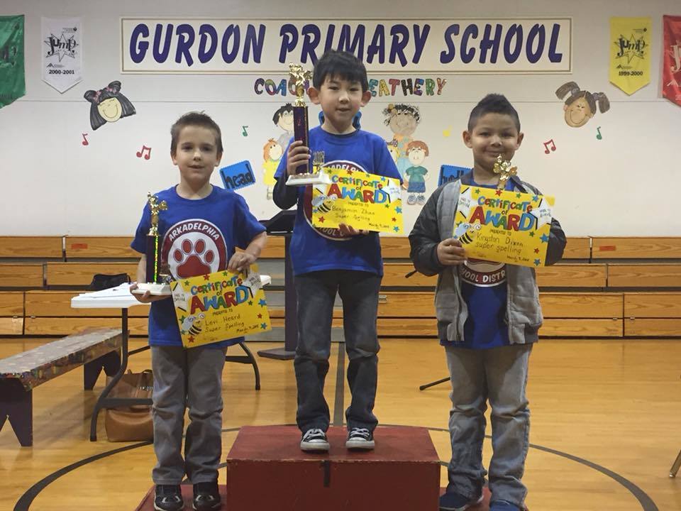 Three Perritt Primary students hold spelling bee trophy