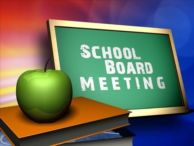 School Board meeting written on chalkboard with an apple and book to the side
