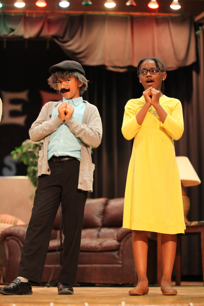 two students performing in musical