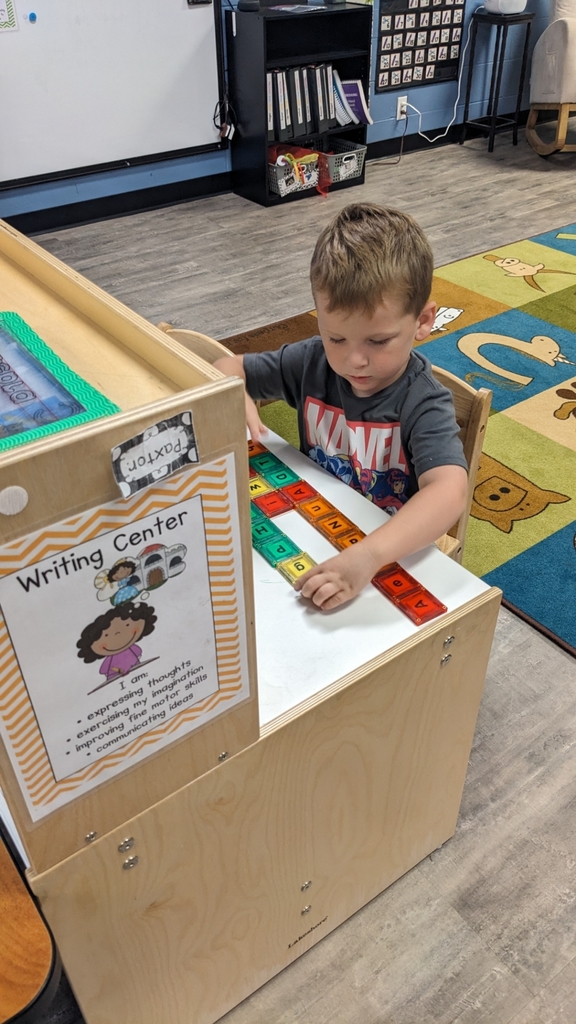 boy playing at the writing center