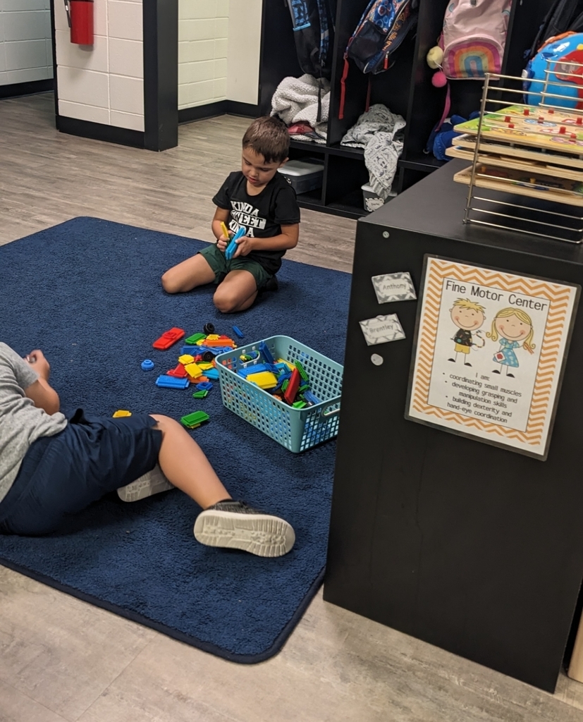 two boys playing at the fine motor center