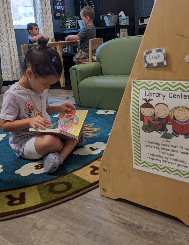 girl reading a book at the reading center