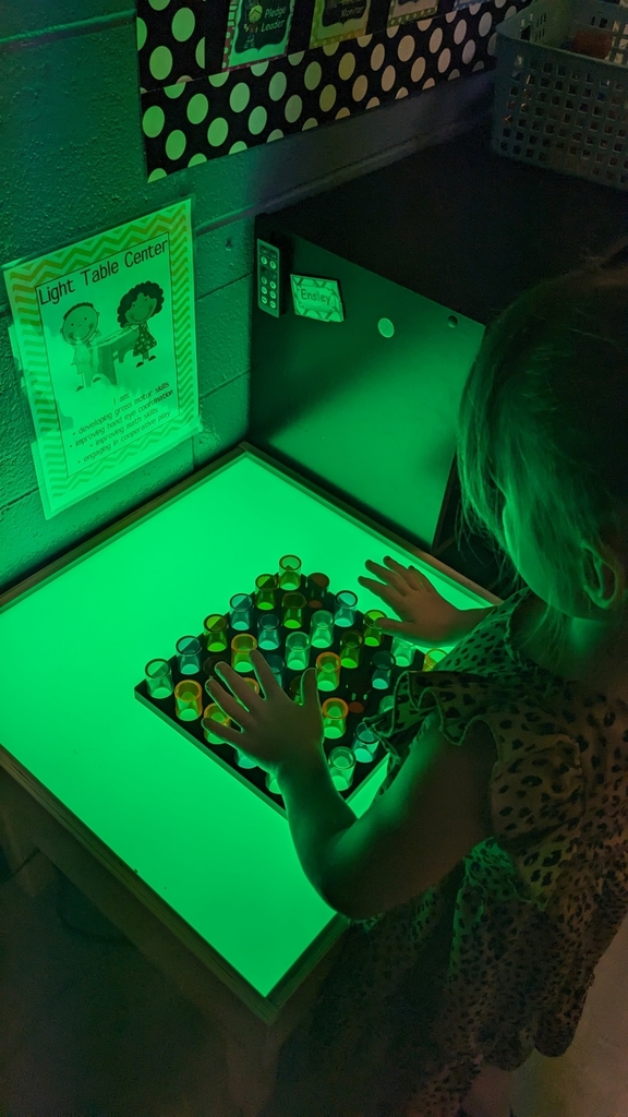 girl playing at the light table